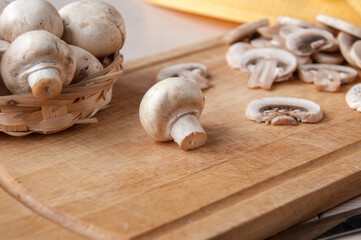 Still life: basket with mushrooms, cutting Board with slices of mushrooms on the table