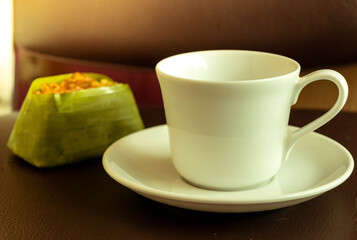 Hot coffee that has no sugar in the cup. White coffee is a breakfast for many, and desserts placed on a healthy black background.