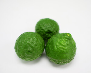 Bergamot, green fruit arranged on a white background