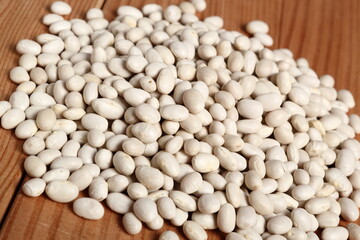 Navy beans at wooden plank background