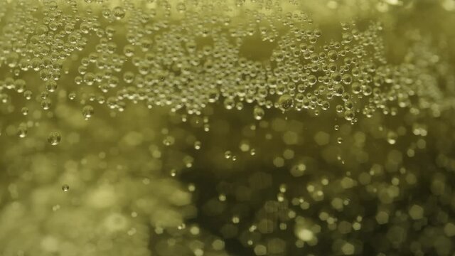 Out of focus bubbles in beer in slow motion