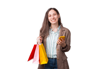 Smiling woman is holding some shopping bags and her phone buying something online