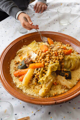 Vertical detail food shot of a traditional moroccan couscous with ingredients; chickpeas, carrot,...