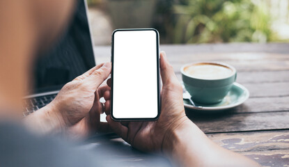 cell phone mockup image blank white screen.woman hand holding texting using mobile on desk at coffee shop.background empty space for advertise.work people contact marketing business,technology