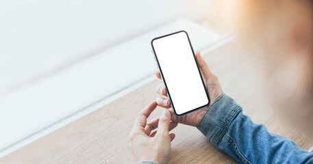 cell phone mockup image blank white screen.woman hand holding texting using mobile on desk at coffee shop.background empty space for advertise.work people contact marketing business,technology
