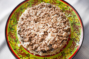 Maqluba is a very old traditional Syrian, Iraqi, Palestinian, and Jordanian dish. It consists of meat, rice, and fried vegetables placed in a pot which is flipped upside down when served.