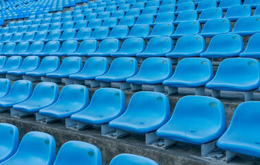 Fototapeta premium blue empty stadium seats creating a pattern.