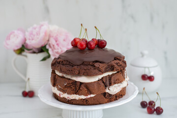 black forest chocolate cake with cherry pie filling with dark chocolate glaze