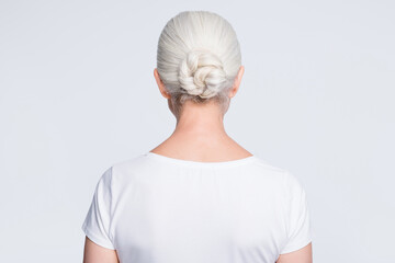 Back rear photo of old lady standing backside wearing t-shirt isolated over white background