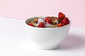 Homemade cereals mini pancake with yogurt, honey and strawberries on colorful background.