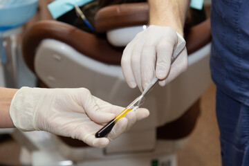 The doctor extracts tweezers plasma from a test tube