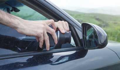 Man takes pictures in car mirror.