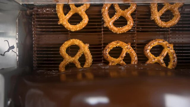 beautiful  Top view footage of  pretzels going through a chocolate enrober 
Can be used for many projects and background!