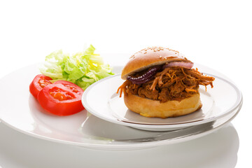 Pulled pork in hamburger bun.