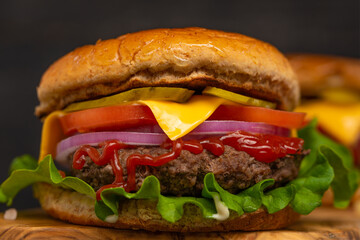 fast food, burger closeup on a wood background, unhealthy but tasty food