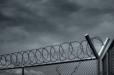 Prison security fence. Barbed wire security fence. Razor wire jail fence. Barrier border. Boundary...