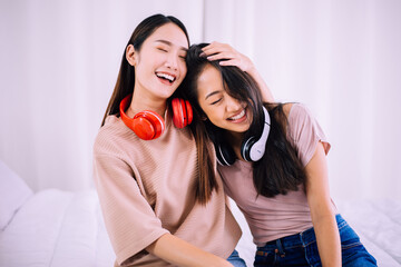 Two young asian women laughing in the living room,Lesbian,LGBT