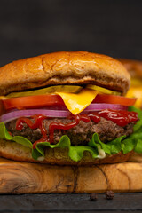Burger on a wooden background close-up, fast food, macro
