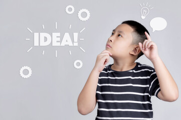 boy is showing finger while having an idea and looking at camera with an open mouth and education concept