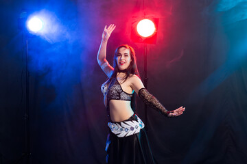 Spirituality dance. Beautiful sexy woman with luxury glossy eastern make-up dancing tribal fusion. Belly dance.