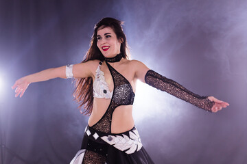 Portrait of a woman in oriental costume performing belly dance. Tribal fusion dance concept.