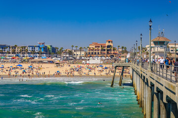 View of the pier, ocean and beach in surf city Huntington Beach, famous tourist destination in California