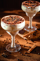 italian dessert tiramisu in an elegant cocktail glass, the concept of sweet life, luxury, delicious food