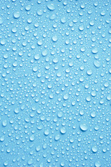 Fototapeta na wymiar Beautiful big drinking water droplets on the light blue background. 