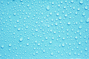 Beautiful big drinking water droplets on the light blue background. 