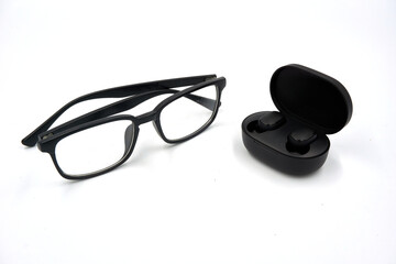 Fototapeta na wymiar Glasses and wireless earphone with charging case