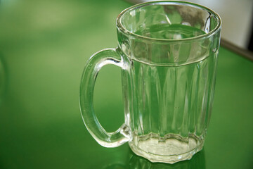 Glass of water on the green table