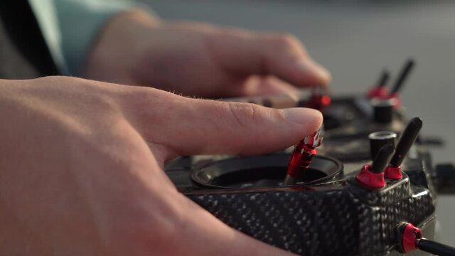 male hands control a remote controller on the street. close-up. fpv drone control