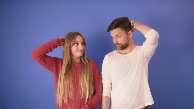 Young worried couple holding their hands on heads after they did something wrong. Lost  opportunity concept