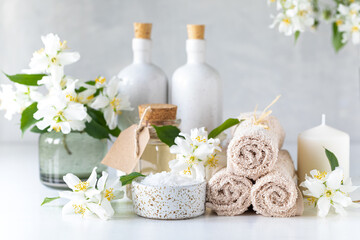 Fototapeta na wymiar Spa composition with jasmine flowers on a white table close-up.