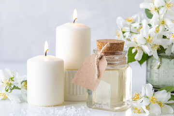 Obraz na płótnie Canvas Spa composition with jasmine flowers on a white table close-up.