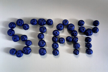 Stay word made from blueberries on a light background