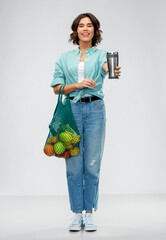 sustainability, food shopping and eco friendly concept - happy smiling woman in turquoise shirt...