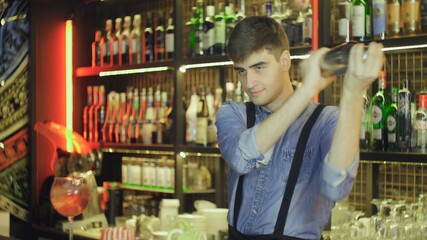 Barman shaking cocktail at a nightclub