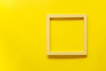 Yellow vintage frame on yellow background. Top view, blank space