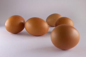 Five fresh eggs on white background
