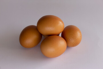 Top view of five fresh eggs on white background