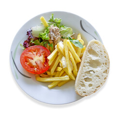 Plate of food. French fries, tomato, salad and bread. Isolated image on a white background. Top view.