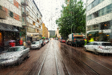 Rain drops on the window with streets of Helsinki, Finland