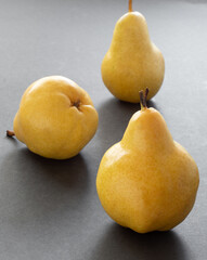 Yellow ripe pears on a black background.