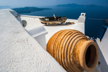 Whitewash Houses overlooking the Caldera of Santorini with large orange pot