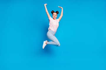 Fototapeta na wymiar Full length body size view of her she nice attractive pretty charming cheerful cheery girl jumping having fun rejoicing rising hands up isolated on bright vivid shine vibrant blue color background