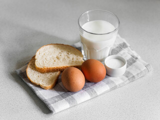 Breakfast ingredients. Still life of eggs, milk and bread on a white background. Close-up