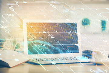 Double exposure of desktop computer and technology theme hologram. Concept of software development.