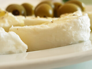 Macro sliced mozzarella with olives. Light snack.
