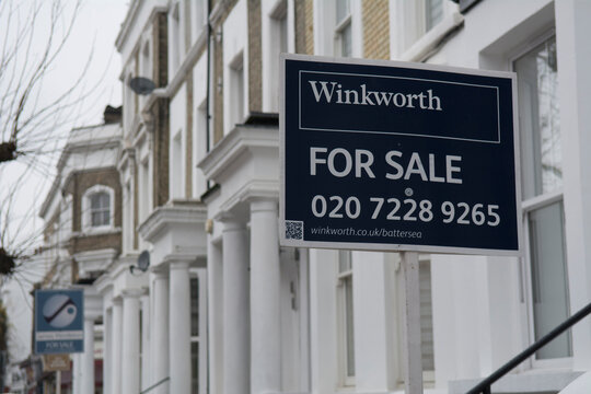 London- Winkworth 'For Sale' estate agent sign  on street of terraced houses